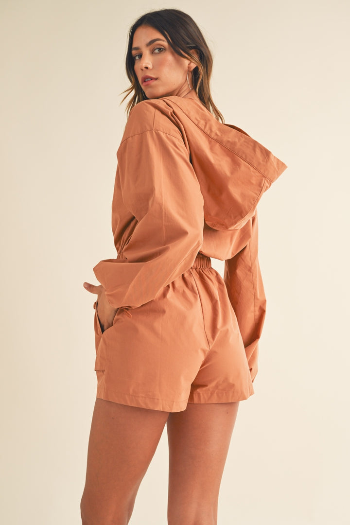 Mable Snap Down Long Sleeve Hooded Romper In Tan